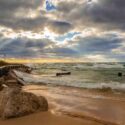 The waves crashing onto the shore of Ludington, Michigan under a clear sky.