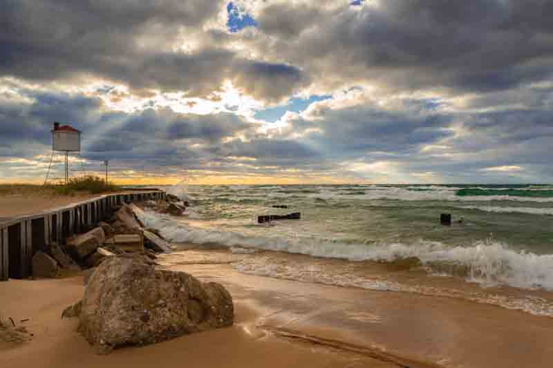 The waves crashing onto the shore of Ludington, Michigan under a clear sky.